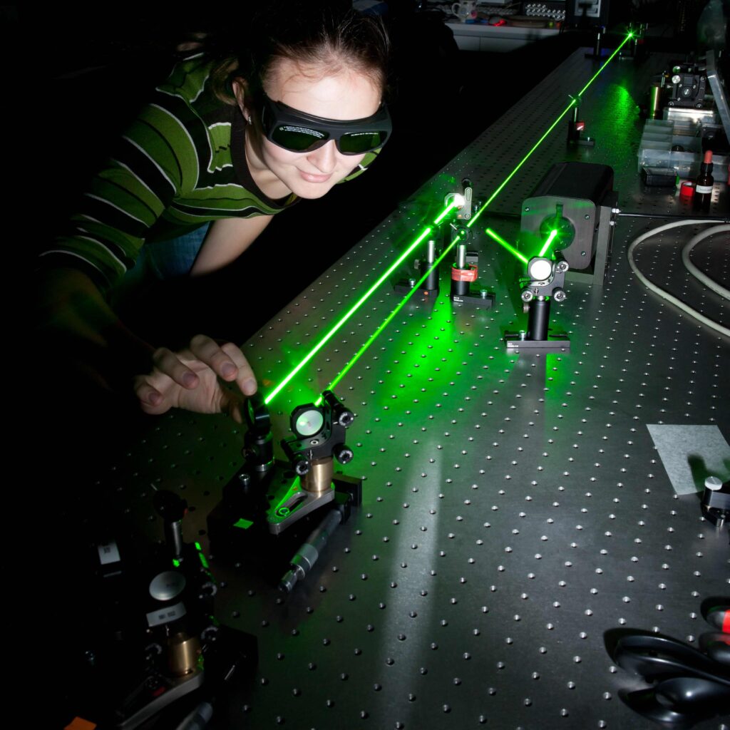 Scientist working with femtosecond laser in an ultrafast electron diffraction laboratory